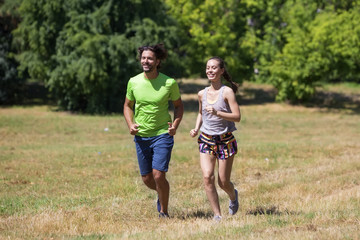 Obraz premium Healthy, fit and sportive couple running in park