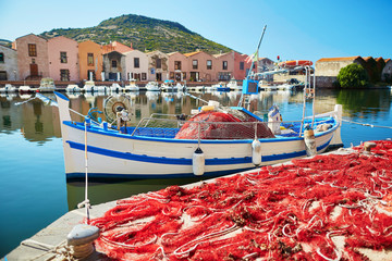 Boat and red fishing net in Bosa, Sardinia