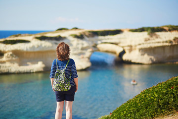 Girl enjoying view to sea coast in Sardinia, Italy