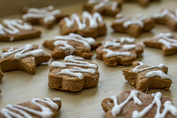 Gingerbread Christmas cookies, on a kitchen table, glazed with white glaze. Concept Christmas.