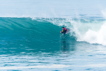 Bodyboarder surfing ocean wave