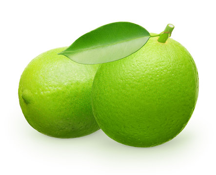 Whole fresh lime fruit with green leaf next to lying