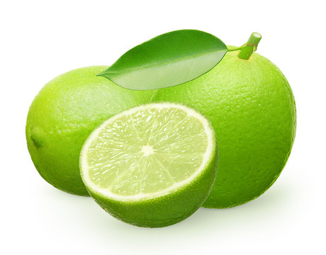 Whole fresh lime fruit with green leaf, lying and half