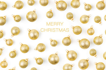 Christmas composition. Pattern made of  golden Christmas balls on wite background. Flat lay, top view