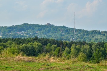 Summer urban landscape. View on Kosciuszko mound from the Zakrzowek lagoon in Krakow.