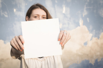 Woman holding white blank paper