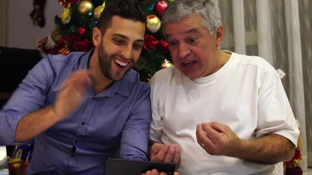 Father and Son Having a Video Chat on Christmas Day