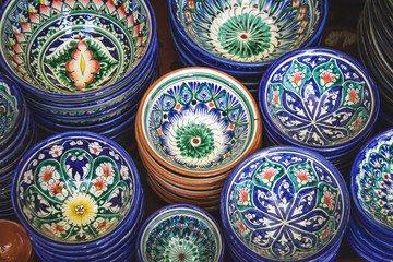 Ethnic Uzbek ceramic tableware. Decorative ceramic cups with traditional uzbekistan ornament.