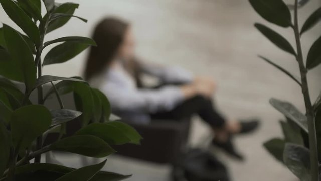 Woman sits in the chair and smiles to camera