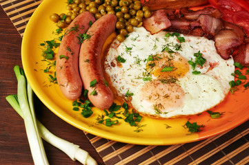 Breakfast - fried egg, tomatoes and bacon.