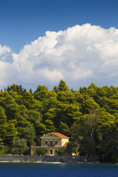 House on Madouri island as seen fromthe sea near Nydri village on Lefkada island in Greece.
