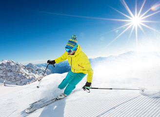 Fototapeta na wymiar Skier skiing downhill in high mountains