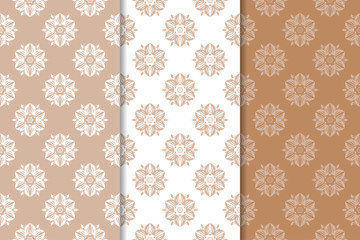 Brown floral backgrounds. Set of seamless patterns