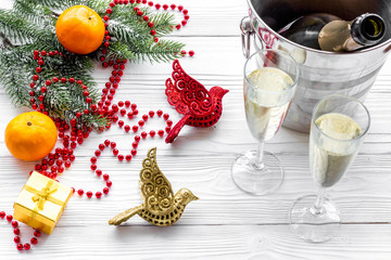 New Year 2018 background. Champagne in bucket, glasses with beverage, tangerines and decoration on grey background