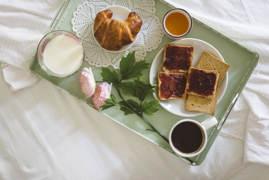 Detail of healthy breakfast on the bed