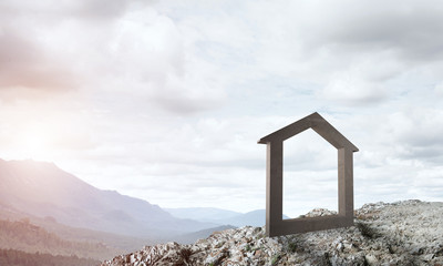 Conceptual image of concrete home sign on hill and natural landscape at background