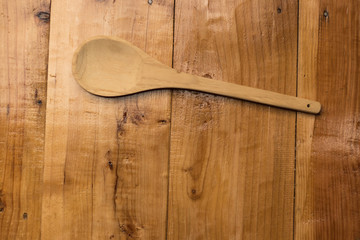Spoon on wooden table top angle view, copy space
