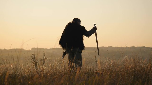 The warrior Viking sticking a swords into the ground