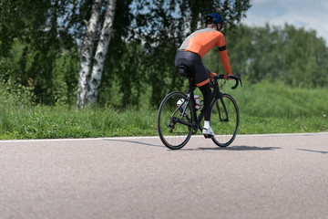 Fototapeta na wymiar a road bike with a cyclist pedaling on a road.