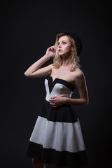 Retro Style. Fashion full Portrait of a Beautiful Young Sexy Woman in black and white striped dress