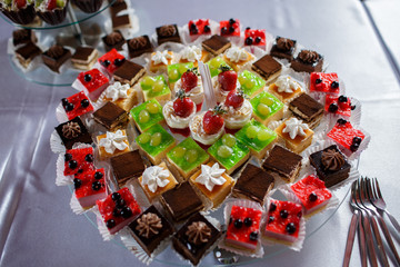 Candy bar with a variety of delicious desserts in the restaurant at the wedding
