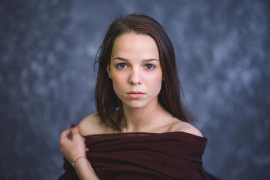 Portrait of a young brunette with sad and serious