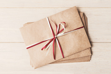 Pile of craft envelopes on wooden background