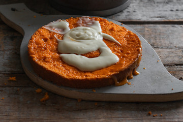 baking cake - greases with white cream orange sponge cake