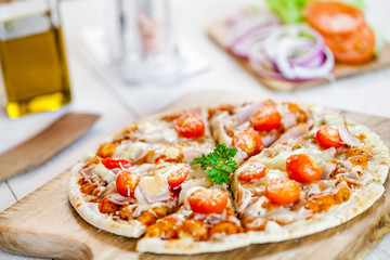 hot fresh homemade traditional italian pizza on wooden table. wallpaper for pizzeria and cooking food concept