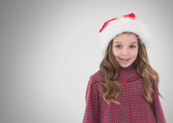 Girl against grey background with Santa Christmas hat