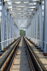 Rails of railway bridge, stretching into perspective