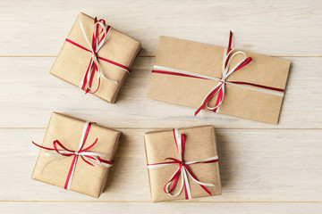 Top view of gift boxes and envelope on wooden background