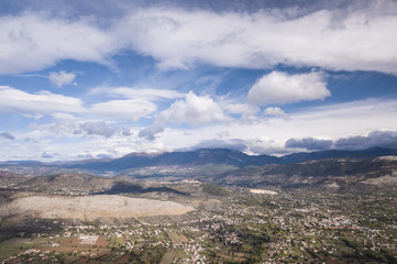 Aerial view of an Italian countryside with a dramatic and cloudy sky.