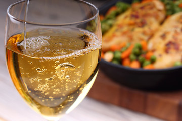 Pouring white wine into glass