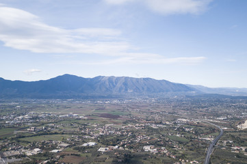 Aerial view of an Italian countryside with a dramatic and cloudy sky.