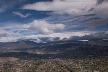 Aerial view of an Italian countryside with a dramatic and cloudy sky.