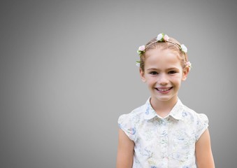 Girl against grey background with flowers in hair