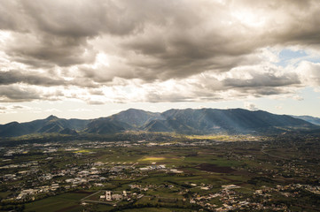 Aerial view of an Italian countryside with a dramatic and cloudy sky.