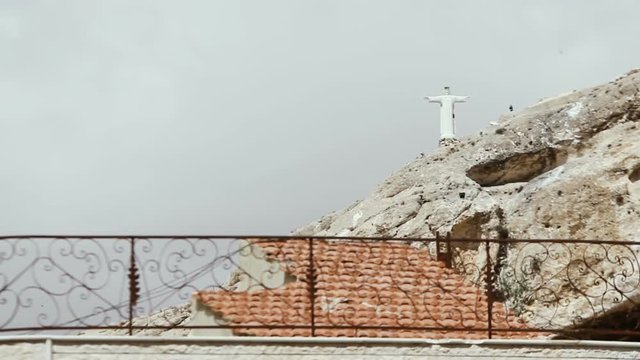 A statue of Jesus on a mountain near the city of Maalula. The statue was badly damaged as a result of the fighting.
