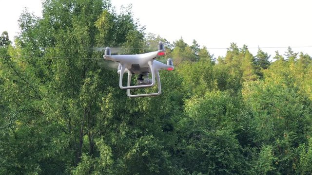DJI4: Quadcopter flight circling in the air left trees blue sky Sunny day summer heat fun light good close-up Phantom Drone camera flying clear sky Aerial Cinematography Quadcopter Drone Technology