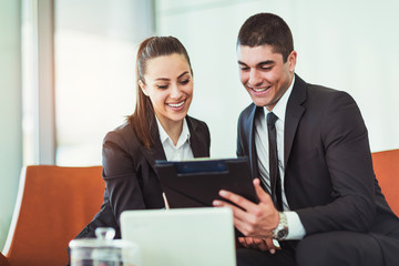 Portrait of business people working on a digital tablet