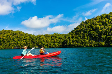 Fototapeta na wymiar Family kayaking in mangroves