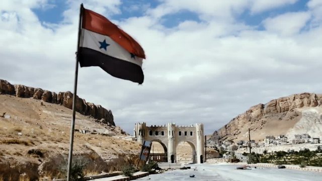 The Syrian flag is set before entering the town of Maalula
