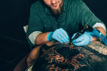 tattoo master artist makes a tattoo. Closeup