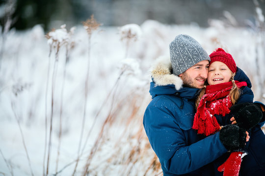 Father and daughter outdoors at winter