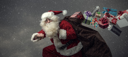 Santa Claus running and delivering gifts