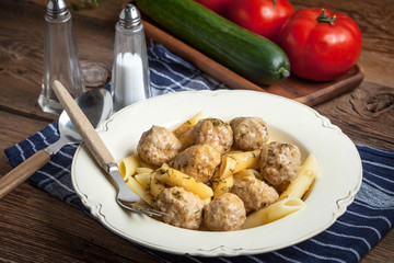 Pork meatballs with dill sauce and pasta. Selective focus.