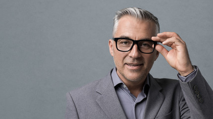 Fototapeta na wymiar Smart businessman with glasses posing