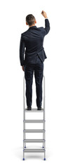 A businessman stands on a metal stepladder and draws with one hand in a back view on a white background.