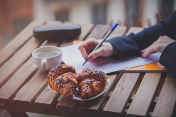 businesswoman writing a balance on a paper